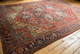Traditional Heriz carpet with cherry red field, geometric medallion, and visibly worn texture.