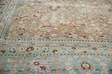 Evenly distressed pile with faded terra cotta, sky blue, pink floral motifs.