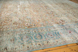 Distressed vintage Persian Meshed rug border, faded sky blue, pink, and ivory, with worn pile.