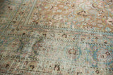 Worn pile and exposed foundation of a distressed vintage Meshed carpet, faded blue, pink motifs.