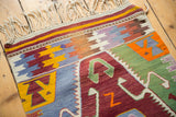 Wine red crab motif with green outline and colorful geometric patterns on the Turkish kilim.