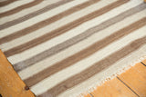 Neutral striped hand-woven Moroccan Kilim rug showing natural wool tones and subtle striations.