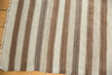 Fringed edge detail of the vintage Moroccan Kilim rug, showcasing natural brown and ivory stripes.