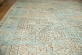Distressed vintage Heriz carpet with geometric sea foam green and coffee brown patterns.