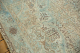 Faded geometric patterns of germinating plants and serrated leaves in sea foam green and sand.