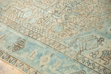 Softened sea foam green and beige geometric patterns with coffee brown accents on a vintage Heriz rug.