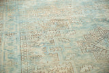 Distressed vintage Heriz rug pile with sea foam green, beige, and coffee brown geometric motifs.