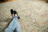 Distressed vintage Heriz carpet showing time-softened ivory and sea foam geometric motifs.