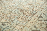 Distressed vintage Heriz carpet detail, showing pale sea foam green and ivory geometric lattice with border.