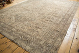 Distressed vintage Shiraz carpet with faded geometric patterns and visible wear.