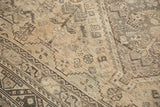 Distressed Shiraz carpet detail: geometric patterns, antique ivory, brown, mostly even wear.