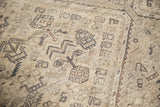 Distressed geometric floral design with exposed foundation, showing ivory and dark brown tones.