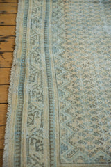 Distressed vintage Mir Arak rug border with visible knot heads, faded blue, and ivory tones.