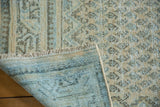 Vintage Mir Arak rug's distressed pile with visible knot heads, boteh motifs, and blue foundation.