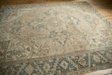 Distressed vintage Mehrivan rug: beige and dusty teal geometric floral border patterns.