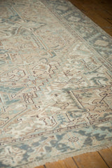 Distressed vintage Mehrivan rug with geometric floral patterns and serrated border in faded beige and teal.