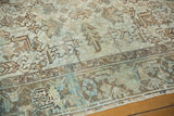 Distressed Mehrivan rug's geometric motifs, low pile, and muted blue-green tones.