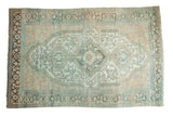 Distressed vintage Malayer carpet with central medallion, geometric floral field, faded teal, ivory, copper.