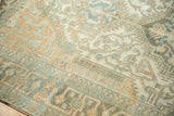 Distressed Malayer carpet showcasing low pile texture, geometric floral motifs, ivory, teal, copper.