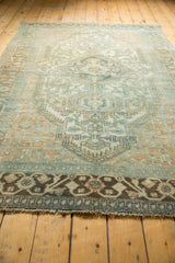 Distressed Malayer rug's secured dark border with geometric motifs and fringed edge.
