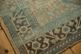 Distressed low-pile Malayer rug border with scrolling floral patterns, teal, brown, ivory.