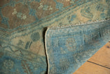 Distressed vintage Northwest Persian rug pile showing wear, faint foundation, and woven aqua blue back.