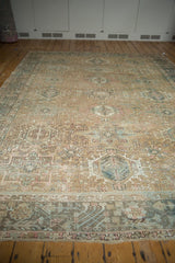 Distressed vintage Karaja rug, repeating multi-medallions, faded floral motifs in sand, teal, blush.