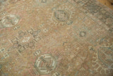 Distressed vintage Karaja carpet, geometric multi-medallion motifs, sand, blush, teal tones.