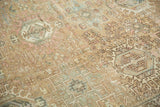 Distressed vintage Karaja rug with time-softened sand, blush, and teal geometric patterns.