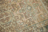 Distressed vintage Karaja carpet close-up showing worn knot heads and intricate geometric motifs.