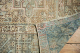 Distressed vintage Karaja rug corner revealing faded sand, teal pile and hand-knotted reverse.