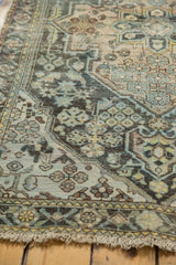 Vintage distressed Hamadan rug with low pile, knot heads, and muted blue, beige patterns.