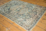 Distressed vintage Hamadan rug corner, highlighting low pile, visible knot heads, and fringe.