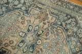 Distressed vintage Hamadan rug showcasing intricate patterns, low pile, in beige and soft blue.