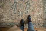 Overhead view of a vintage Ahar rug's distressed low pile and central starburst medallion.