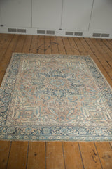 Angled view of a vintage Ahar rug's curvilinear design in powder blue and coffee brown.