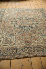 Angled perspective of a distressed Persian Ahar rug's intricate pattern and low pile.