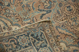 Folded corner of a vintage Ahar rug shows its hand-knotted back and time-softened low pile.
