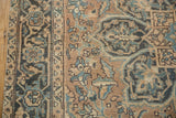 Low pile texture of a vintage Ahar rug showing stylized floral designs in pale teal and coffee brown.