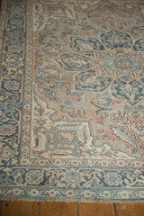Corner detail of a vintage Ahar rug showing stylized floral motifs and its low pile texture.