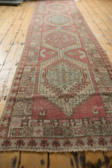Distressed Serab runner with pale raspberry field and a powder blue geometric medallion.