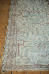 Distressed vintage Malayer runner's intricate border and faded powder blue, wine red patterns.