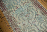 Distressed Malayer runner featuring faded powder blue, wine red motifs, and visible wear.