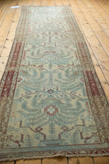 Distressed Malayer runner end: worn fringe, foundation showing, powder blue, wine red.