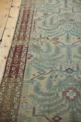 Vintage distressed Malayer runner: textured pile, wine red border, powder blue motifs.