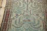 Distressed Malayer runner featuring muted wine red, powder blue willow tree motif.