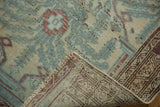Worn pile and tightly woven foundation of a distressed vintage Malayer rug.