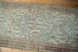 Distressed vintage Malayer runner pile showing exposed foundation, powder blue willow motif.