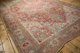 Distressed vintage Persian Heriz corner, revealing worn geometric motifs in blush, ivory, and pale bronze.