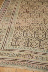 Vintage Distressed Kurdish rug close-up: pale green Laleh Abassi border, charcoal field.